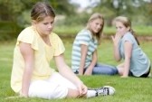 3487178-two-young-girls-bullying-other-young-girl-outdoors